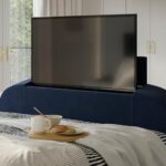Navy velvet-touch bed frame, showing the foot end with built-in TV and breakfast tray